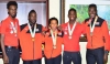 MEDAL STARS: Trinidad and Tobago's four individual medal winners and the captain of the gold medal-winning Girls beach soccer team pose with their Commonwealth Youth Games hardware at the VIP Lounge at Piarco International Airpot Tuesday night upon the team's return home from the Nassau, Bahamas event. From right are Tariq Horsford (silver) Jeron Thompson (bronze), Nia Honore (gold), Adell Colthrust (gold) and Jabari Grey (silver). —Photo: STEPHEN DOOBAY MEDAL STARS: Trinidad and Tobago's four individual medal winners and the captain of the gold medal-winning Girls beach soccer team pose with their Commonwealth Youth Games hardware at the VIP Lounge at Piarco International Airpot Tuesday night upon the team's return home from the Nassau, Bahamas event. From right are Tariq Horsford (silver) Jeron Thompson (bronze), Nia Honore (gold), Adell Colthrust (gold) and Jabari Grey (silver). —Photo: STEPHEN DOOBAY