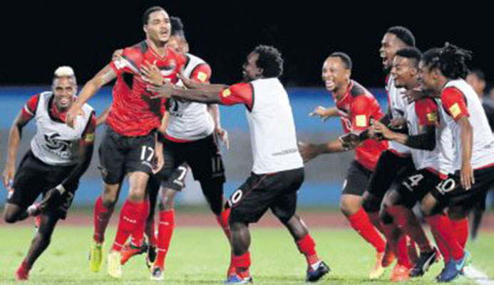 Trinidad and Tobago’s Alvin Jones (17) celebrates with teammates after scoring against United States in their final round Concacaf Zone World Cup qualifier at the Ato Boldon Stadium, Couva, last night. T&T won 2-1 to end the USA’s hopes of reaching Russia. PICTURE AP