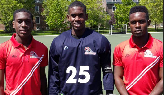 Former national under 21 goalkeeper Kwasi Emmanuel, centre, poses with his brothers Kristien and Keiron at the 2016 Pan Am Hockey Tournament in Canada.