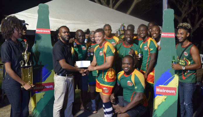 The winning Hornet's team celebrate while receiving their trophy and prize money