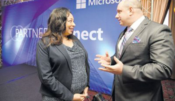 Racquel Moses, country manager, Microsoft T&T, and Herbert Lewy, general manager, Microsoft Caribbean, speak during the Microsoft Trinidad and Tobago Partner Connect at the MovieTowne Banquet and Conference Centre Port-of-Spain yesterday. PICTURE ANISTO ALVES