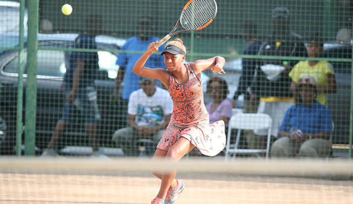 Solange Skeen plays a return shot during the Women’s Singles Finals of the Shell Tranquillity Open Tennis Championships at Victoria Avenue, Port-of-Spain, yesterday. Photo by:Allan V. Crane