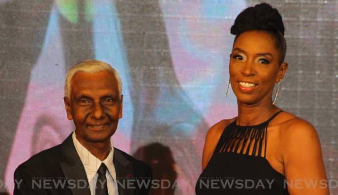 TT Olympic Committee’s Dr Terry Ali (L) presents the Sportswoman of the Year award to Euphemia Huggins, who collected the award on behalf of her daughter and TT cyclist Teniel Campbell, at the TTOC’s awards ceremony, at the Hyatt Regency, Port of Spain,on Sunday. - ROGER JACOB