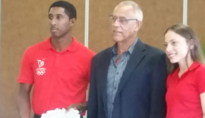 Defence Force’s Mickell Pierre, left, who was named the T&T Hockey Board (TTHB) "Sportsman of the Year" is with Kaitlyn Olton, who collected the women’s award for her sister Amy of Shandy Carib Magnolias and Douglas Comacho, president of the TTHB, at the board’s awards ceremony at the National Racquet Centre in Tacarigua, yesterday.