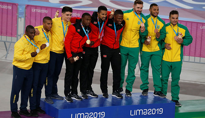 Colombia which won silver, left, T&T which won gold with Keron Bramble, Njisane Phillip and Nicholas Paul, and team Brazil which won bronze, pose for photos during the medal ceremony for the men's cycling track team sprint at the Pan American Games in Lima, Peru on Thursday. (AP)