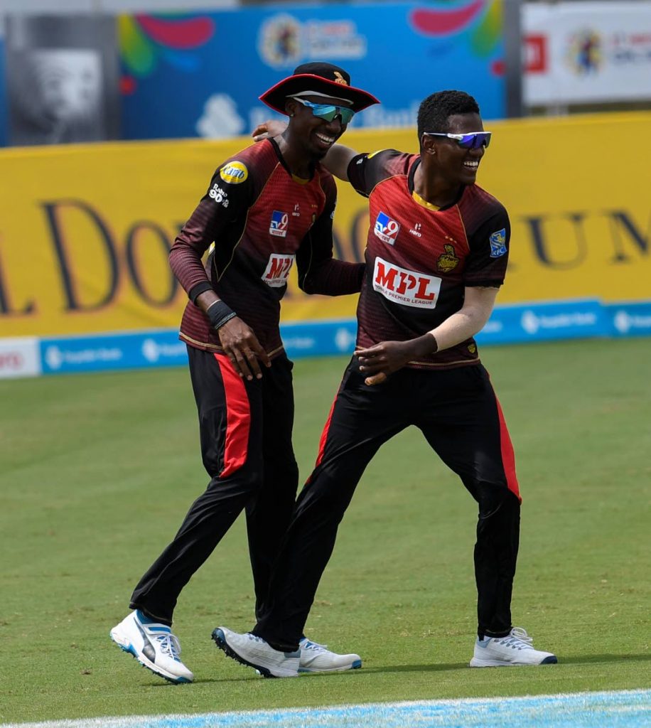 In this file Sep 2 file photo, Khary Pierre (left) and Akeal Hosein of Trinbago Knight Riders celebrate the dismissal of Alzarri Joseph of St Kitts/Nevis Patriots during the teams’ Hero Caribbean Premier League match 23 at the Brian Lara Cricket Academy, Tarouba. (Photo by CPL T20 via Getty Images) -