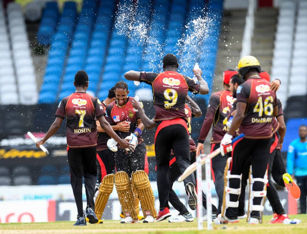 Lendl Simmons (2L) and Trinbago Knight Riders team-mates celebrate winning the Hero Caribbean Premier League 2020, at Brian Lara Cricket Academy,Tarouba, on Thursday. - CPL T20 via Getty Images