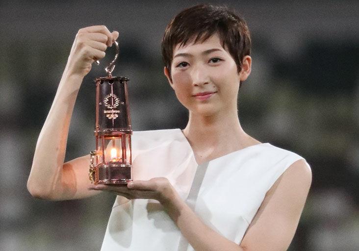 THE COUNTDOWN STARTS: Japanese swimmer Rikako Ikee holds a lantern containing the Olympic flame during an event yesterday marking one year until the postponed Tokyo 2020 Olympic and Paralympic Games, at the National Stadium in Tokyo.  —Photo: AFP