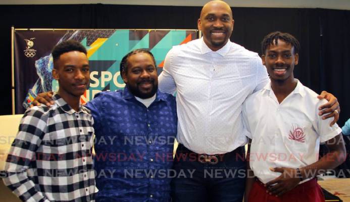 Kibwe Trim (second from right), former professional basketballer and founder of DreamChaser International Foundation interacts with brothers Zion Nicholas, left, and Israel Nicholas, right, recipients of the Scholar Athlete of the Year Award 2020 from the DreamChaser International Foundation, alongside their father Kieno Nicholas at the annual TT Olympic Committee Sport Industry Conference 2020, held at the Hyatt Regency, Port of Spain, last Thursday. - ROGER JACOB