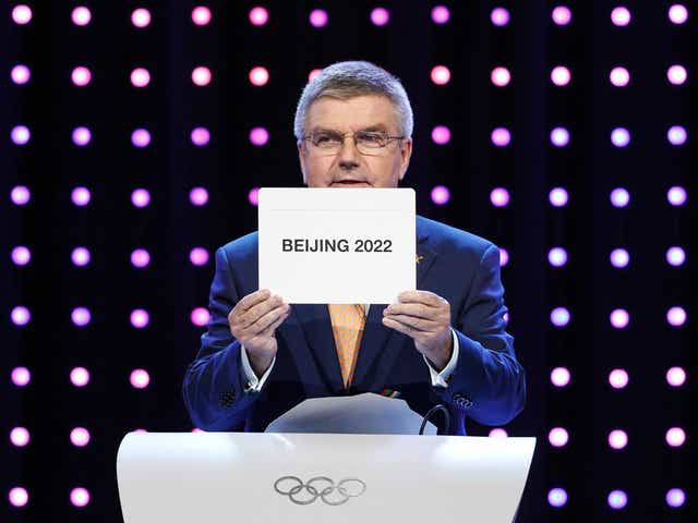 IOC president Thomas Bach opens the envelope announcing that Beijing has won the bid to host the 2022 Winter Olympic Games on July 31, 2015. JOSHUA PAUL, AP