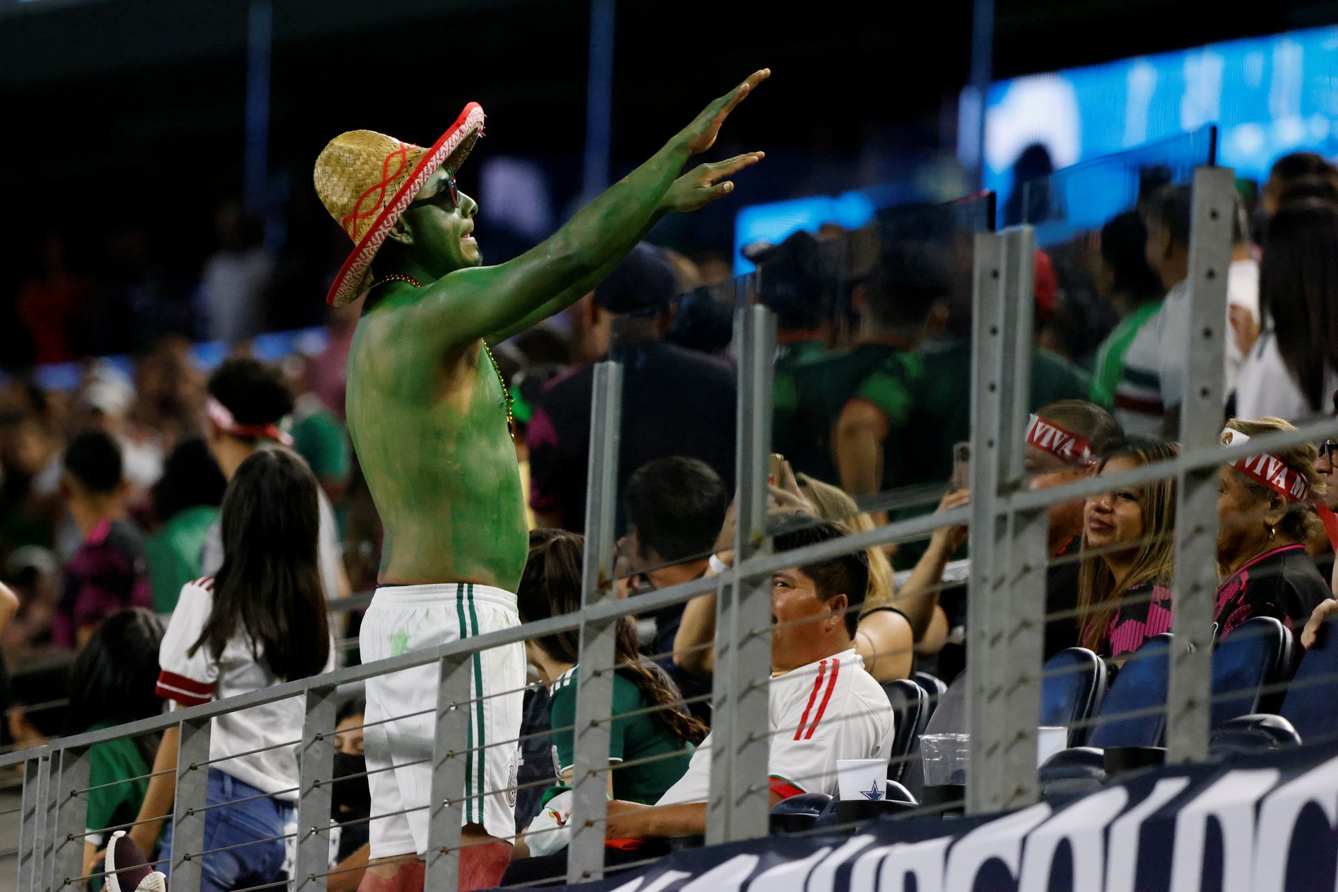 A Mexico fan tries to calm down the crowd, which was threatened with a suspended game as Mexico played to a 0-0 draw against Trinidad and Tobago, during the second half of a CONCACAF Gold Cup Group A soccer match in Arlington, Texas,USA on Saturday. (AP Photo/Michael Ainsworth)  Michael Ainsworth