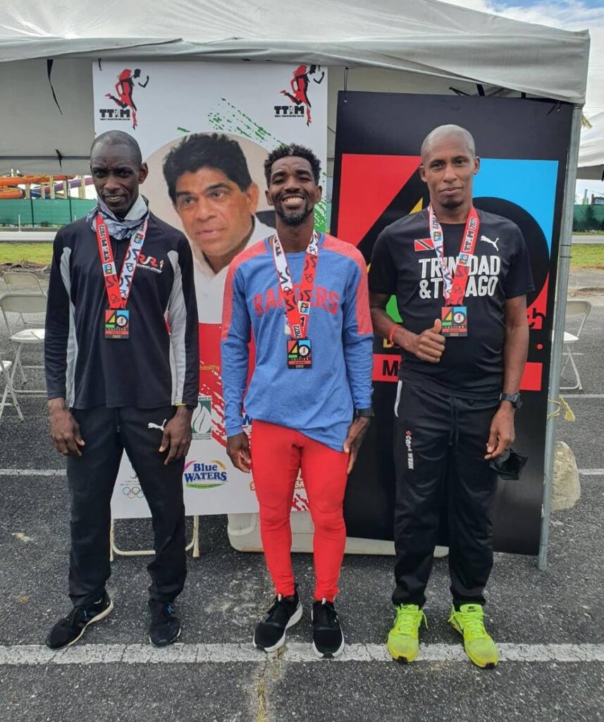 TTIM winner Kelvin Johnson (Guyana), centre, with second placed Elvis Turner, left, and third placed Curtis Cox. -