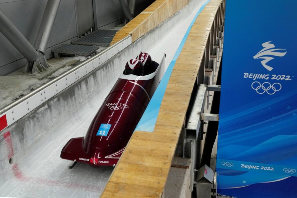 Axel Brown and Andre Marcano of Trinidad and Tobago speed down the track during a 2-man bobsleigh training heat at the 2022 Winter Olympics, on Saturday, in the Yanqing district of Beijing. (AP PHOTO) -