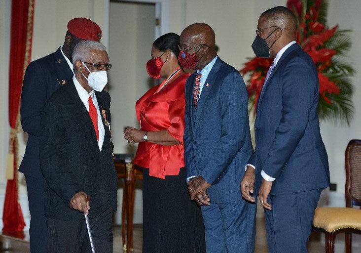 NOT FORGOTTEN: Edgar Vidal, former coach of the national senior football team, speaks with Prime Minister Dr Keith Rowley, centre, and Chief Justice Ivor Archie after being presented with the Chaconia Medal (Silver), in the spheres of sport and community service, by President Paula-Mae Weekes at the 2020 national awards ceremony at President’s House, St Ann’s, on Monday. —Photo: ISHMAEL SALANDY
