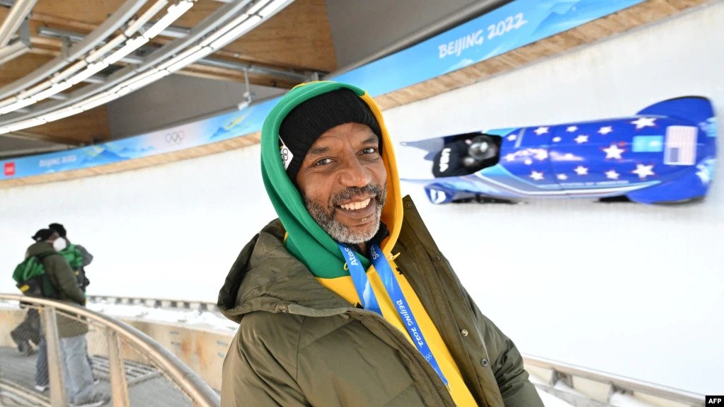 Chris Stokes poses for a photo by the track as the 2-man bobsled training takes place during the Beijing 2022 Winter Olympic Games in Yanqing on Feb. 10, 2022.