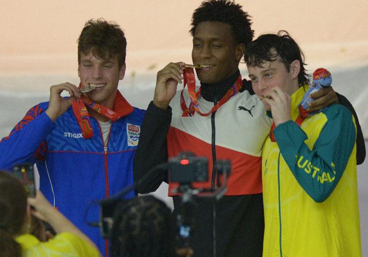 NEW NATIONAL AGE-GROUP RECORD: Team TTO’s Nikoli Blackman celebrates his gold medal-winning effort in the men’s 200m freestyle yesterday, at the National Aquatics Centre in Couva, during the Commonwealth Youth Games (CYG). Cayman Islands’ James Allison, left, secured silver while Australian Harvey Larke completed the podium, bagging bronze. —Photo: DEXTER PHILIP (Image obtained at trinidadexpress.com)