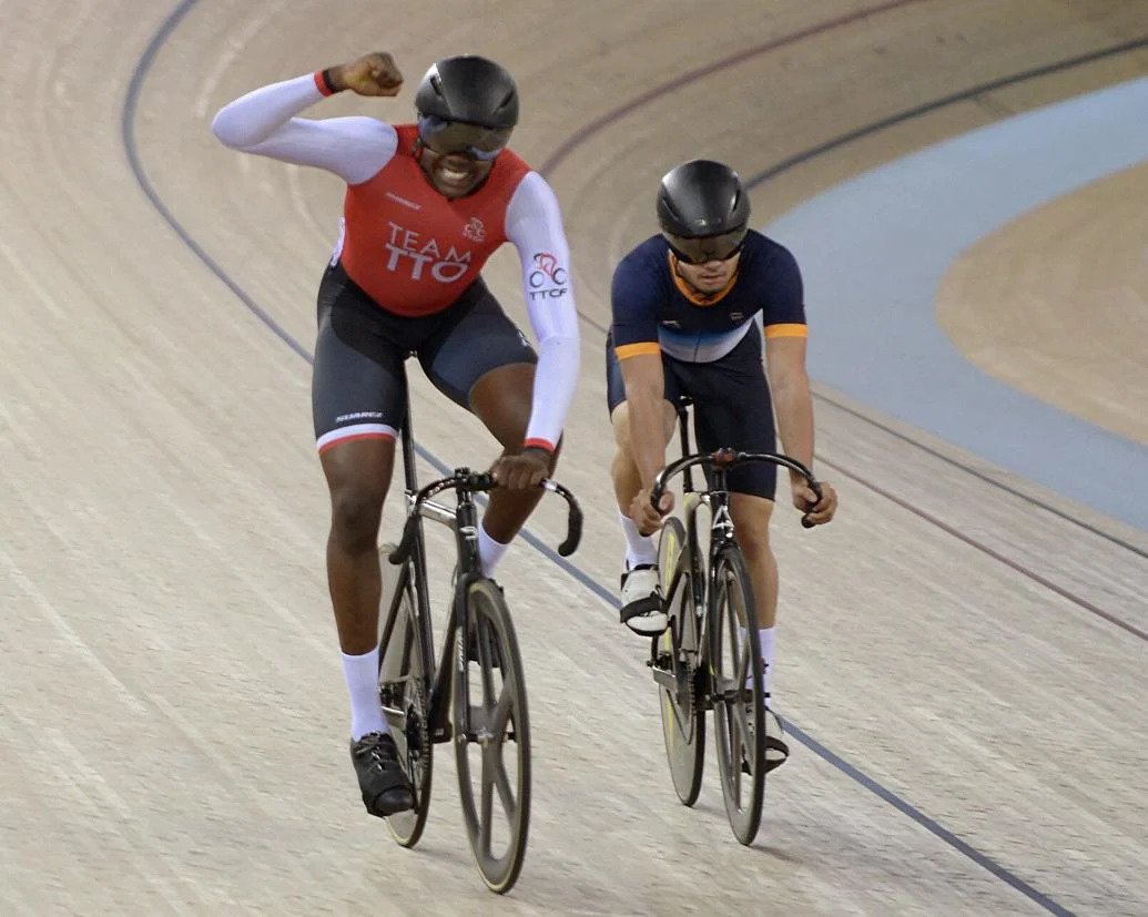 ‘YEESSS’: T&T cyclist Dannel James, left, acknowledges the crowd after winning his second ride in the qualifying phase for the men’s sprint event, against India’s Jitendra Vedant Jadhav, at the National Cycling Velodrome, Couva, on Tuesday. James went on to cop the bronze medal, yesterday. --Photo: DEXTER PHILIP    DEXTER PHILIP (Image obtained at trinidadexpress.com)