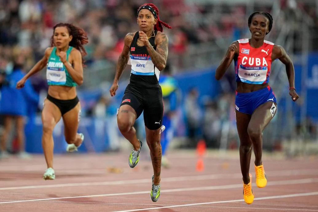 CRUISING: Cuba’s Yunisleidy Garcia, right, leads home Trinidad and Tobago’s  Michelle-Lee Ahye in a women’s 100 metres semi-final heat,  last evening, at the Pan American Games in Santiago, Chile. —Photo: AP  Natacha Pisarenko (Image obtained at trinidadexpress.com)