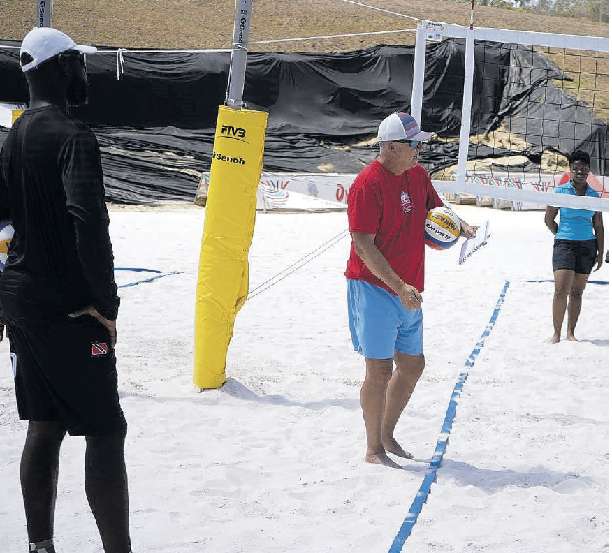 Instructor Rick Bevis, centre, engages participants at the TTVF international beach volleyball course at Courland Beach Sports Facility in Black Rock, Tobago on March 24. TT beach volleyball coach David Thomas. left, looks on. - Photo courtesy TT VF (Image obtained at newsday.co.tt)