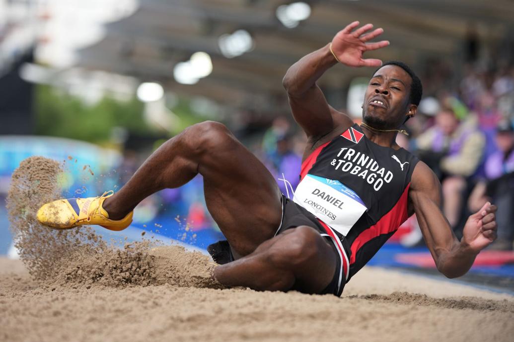 GOOD LEAP: Trinidad and Tobago’s Kelsey Daniel competes in the men’s long jump qualification during the athletics competition at the Commonwealth Games in Glasgow, Scotland, yesterday. —Photo: AP  Alastair Grant (Image obtained at trinidadexpress.com)