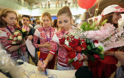 Adulation: Members of Russia's 2012 Olympic team signed autographs for adoring fans who flocked to Moscow's Sheremetyevo international airport to greet their heroes