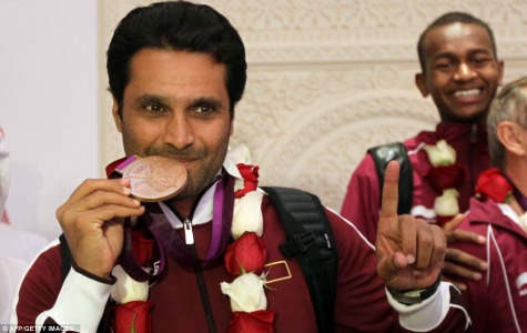 It's the real deal: Qatar's Nasser al-Attiyah is pictured with his bronze medal clamped between his teeth. Champions biting on their medals has become a familiar sight during the 2012 Games