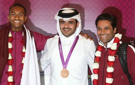 High praise: Qatar's bronze medal winners Natar al-Attiyah, right, and Muttaz Essa Barshim, left, were greeted by Shiekh Joaan bin Hamad bin Khalifa al-Thani (pictured centre), the son of the Emir of Qatar, when they arrived home from London