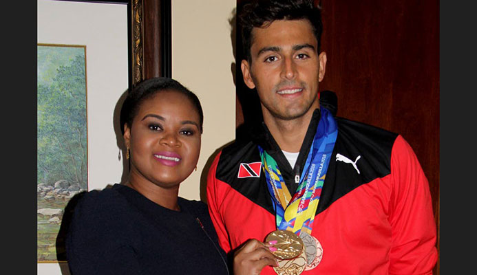 Shamfa Cudjoe, Sports Minister (left) holds one of Dylan Carter’s five medals that he earned at the CAC Games in Barranquilla, Colombia. Cudjoe met the TT swim team upon their return home at the VIP Lounge, Piarco International Airport yesterday. Shamfa Cudjoe, Sports Minister (left) holds one of Dylan Carter’s five medals that he earned at the CAC Games in Barranquilla, Colombia. Cudjoe met the TT swim team upon their return home at the VIP Lounge, Piarco International Airport yesterday.