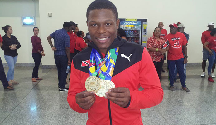 GOLD GALORE: TT cyclist Nicholas Paul shows off his three CAC Games gold medals on his return at the Piarco International Airport yesterday from Colombia. GOLD GALORE: TT cyclist Nicholas Paul shows off his three CAC Games gold medals on his return at the Piarco International Airport yesterday from Colombia.