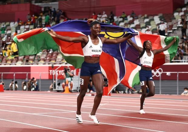 Namibia's Beatrice Masilingi, left, celebrates with teammate and silver-medal winner Christine Mboma after the women's 200m final at the Tokyo Olympics in Japan on Tuesday. (Ryan Pierse/Getty Images)